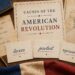 American Revolution teaching materials on a desk with notes about taxes, protest, and representation